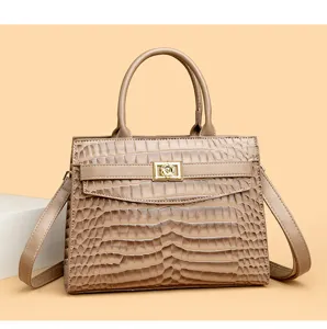 Detailed view of a premium taupe crocodile-embossed tote bag with elegant gold-tone lock
