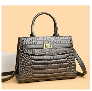Elegant grey crocodile embossed leather handbag with unique gold flower clasp detail