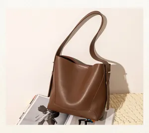 Minimalist brown faux leather bucket bag with spacious interior for daily commute