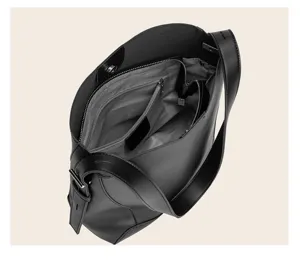 Interior view of large capacity black leather bucket bag showing internal zipper pocket