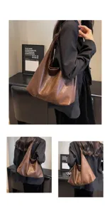 Detailed view of a vintage brown wrinkled leather hobo bag on a model's shoulder