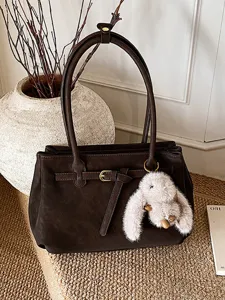 Vintage dark brown matte suede handbag with belt buckle and rabbit charm detail