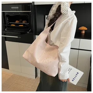 Vue lifestyle d'un cabas rose de style chinois avec broderies dorées et motifs de bambou