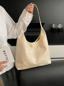 Sac cabas crème élégant avec broderie papillon complexe, idéal pour un trajet de bureau chic.
