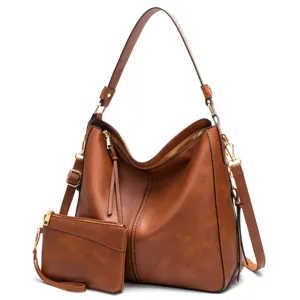 Detailed view of brown vintage hobo bag set with matching small clutch and gold hardware