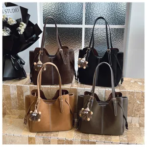 Group of four large capacity tote bags in various colors on display for stylish commuting