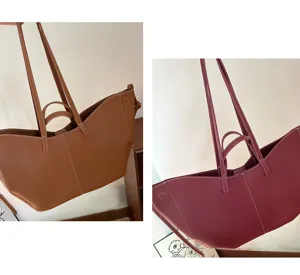 Detailed view of two large-capacity bucket tote bags in cognac and burgundy leather