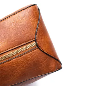 Close-up detail of retro brown textured synthetic leather and high-quality gold zipper