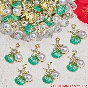 Detailed macro view of green shell and starfish pendants with pearls for DIY jewelry craft
