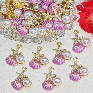Macro view of purple enamel seashell and pearl charms for elegant DIY jewelry crafts