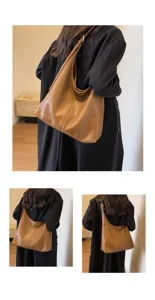 Back view of model wearing a vintage brown faux leather hobo bag with a black coat