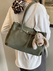 Vintage olive green matte tote bag featuring a belt buckle strap and plush bunny charm