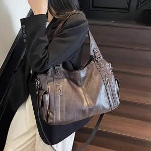 Fashionable large capacity brown leather tote bag for women's commuting and travel.