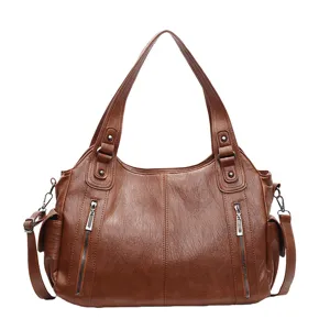 Large brown faux leather tote bag with double handles and adjustable shoulder strap