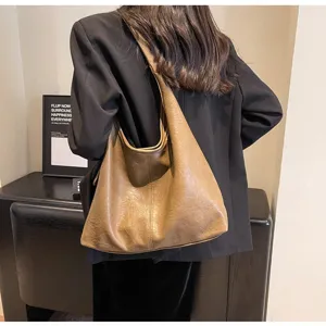 Vintage brown hobo bag with crinkled leather texture styled with a black blazer outfit