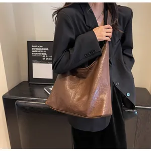 Stylish vintage brown faux leather hobo bag for women shown in a lifestyle setting