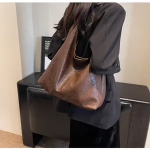 Vintage brown faux leather tote bag for women shown as a stylish shoulder bag