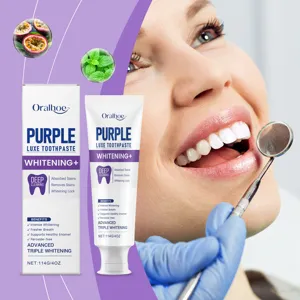 Close-up of Oralhoe purple toothpaste showing whitening effect on teeth and dental tool