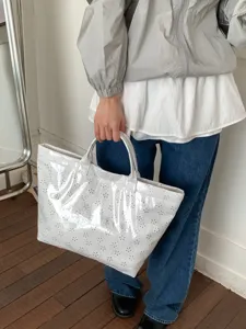 Stylish white PVC tote bag featuring delicate laser-cut floral patterns for spring