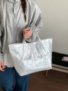 White double-layer PVC tote bag with laser-cut floral patterns for commuting
