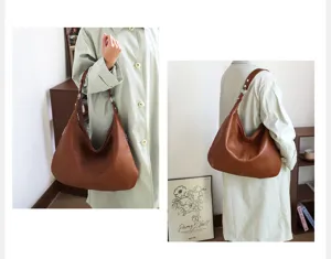 Detailed view of a retro brown oil wax leather hobo bag worn by a model for commute