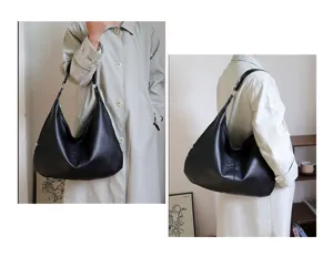 Large capacity black oil wax leather tote bag shown on model in minimalist setting