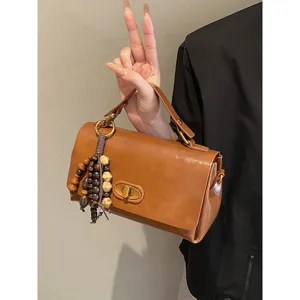 Vintage brown faux leather small square handbag with decorative wooden bead tassel