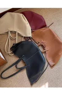 Large capacity minimalist leather bucket tote bags in black, brown, and beige tones