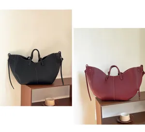 Large capacity bucket tote bags shown in black and maroon faux leather with stitch details