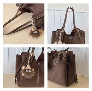 Detailed views of brown suede-like large capacity tote bag with cute monster keychain.