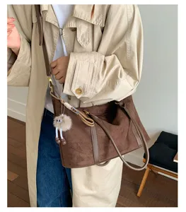 Vintage brown suede bowling bag with large capacity, shoulder strap and plush charm