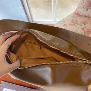 Interior detail of a minimalist brown soft leather large capacity hobo shoulder bag