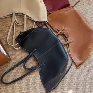 Premium large capacity bucket style tote bags in multiple colors on a textured carpet