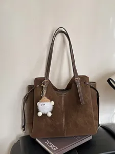 High-capacity brown faux suede tote bag for women featuring a cute white fuzzy charm