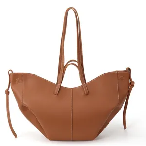 Large brown pebbled leather tote bag with white contrast stitching and dual handles