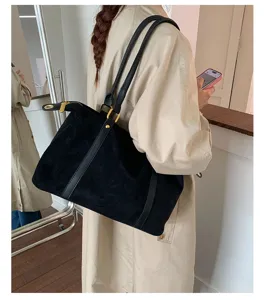 Large vintage black suede bowling bag for women shown as a stylish commuting shoulder bag