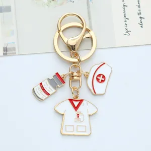 Gold medical keychain for Nurse's Day featuring uniform, nurse hat and medicine vial charms