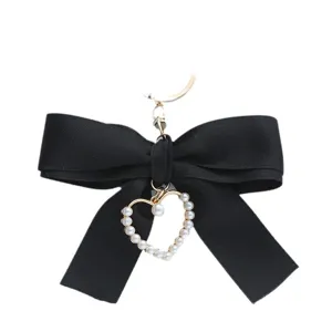 Elegant black fabric ribbon bow keychain featuring a pearl heart pendant for bags