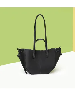 Detailed view of a vintage black leather wing tote bag with white contrast stitching.