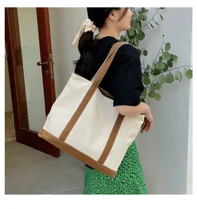 Lifestyle view of a large capacity canvas tote bag with brown contrast straps for women