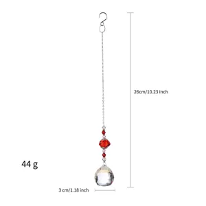 Detailed view of faceted crystal suncatcher with decorative red beads and silver hanging chain