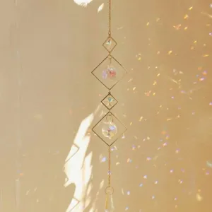 Elegant geometric crystal suncatcher creates beautiful rainbow prism reflections on walls.