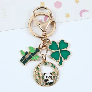 Detailed view of a cute Chinese-style panda keychain with bamboo and clover charms