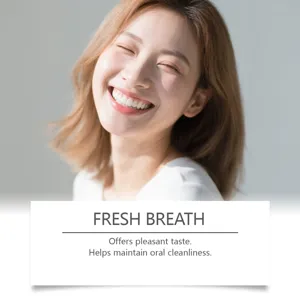 Asian woman smiling showing white teeth for fresh breath mouthwash detail view
