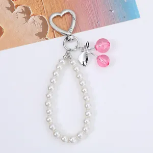 Close-up of a sweet cherry pearl chain keychain featuring heart-shaped clasp and pink beads