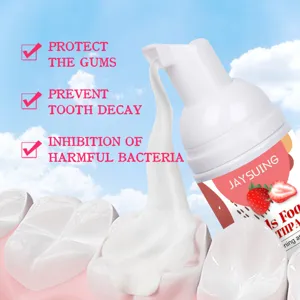 Detail of JAYSUING strawberry kids foam toothpaste dispensing onto teeth model