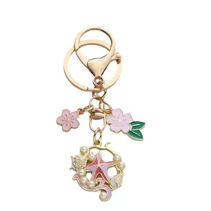 Porte-clés océan avec étoile de mer, fleur de cerisier et perle en alliage d'or