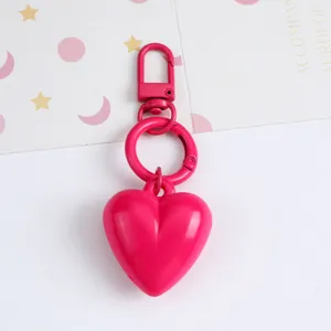 Close-up detail of a vibrant hot pink resin heart keychain pendant with matching metal ring