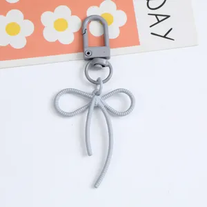 Grey textured bow keychain pendant with swivel hook for bags and accessories