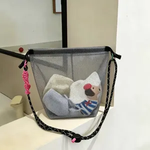 Detail of gray mesh travel beach bag with durable rope strap and buckle design
